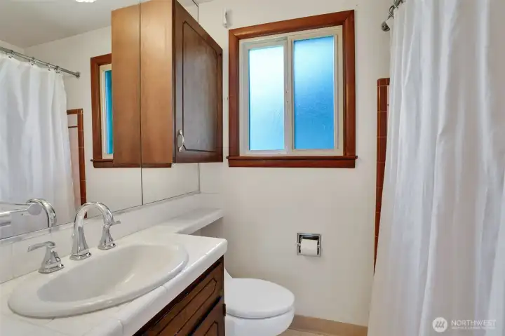 Full bath in the hall, also has 2nd vanity and full size storage closet
