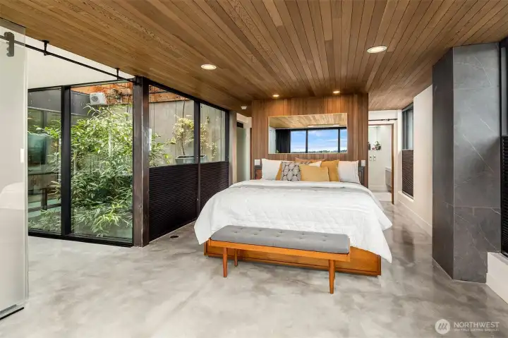 Primary bedroom suite with private balcony showcasing water views