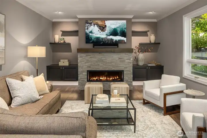 The family room has a gas fireplace and floating shelves with under-cabinet lighting.