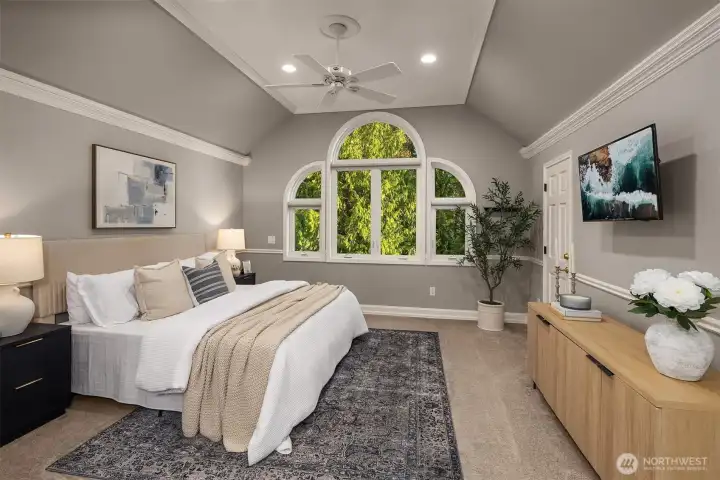 The primary bedroom has vaulted ceilings and two walk-in closets.