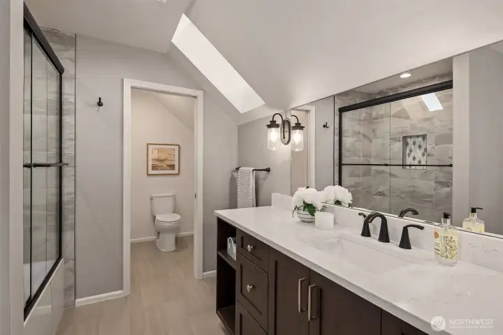 Full bathroom on the 2nd floor with a southwest facing skylight.
