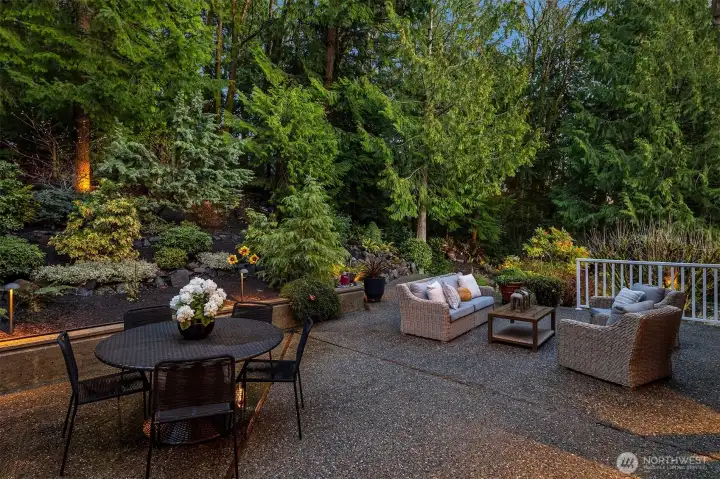 The back patio is filled with soothing sounds as the waterfall runs into the upper pond.