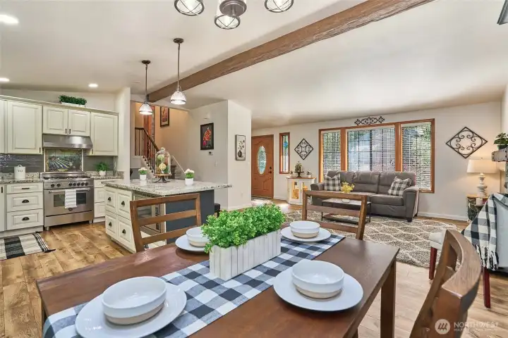 Open-concept living with seamless Laminate wood flooring, an updated kitchen, and wood-wrapped doors and windows that beautifully blend timeless character with modern comfort.