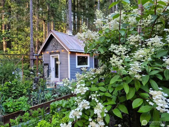 Fenced garden with raised beds, beautiful potting cottage, and rain-collection system for sustainable gardening. A gardener's dream!!!
