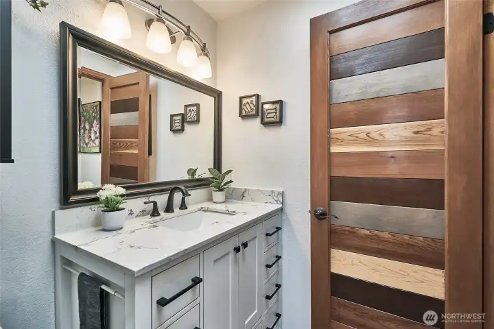 Beautifully updated main bathroom featuring tile flooring and a light, bright design that feels fresh and inviting.