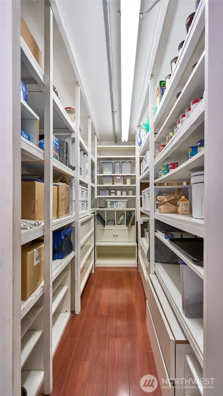 Pantry area featuring floor-to-ceiling shelving that provides an abundance of organized storage space for kitchen and household essentials.