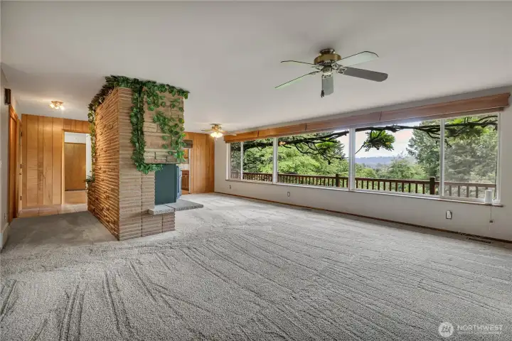 Livingroom has wall to wall windows overlooking valley views