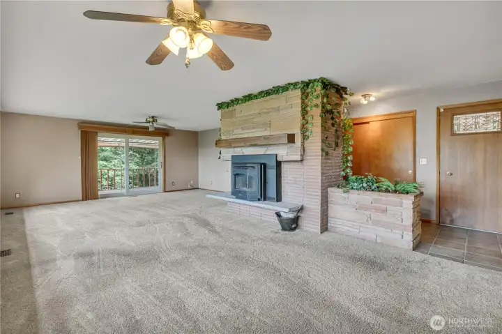 Sliding glass door opens to covered, wrap around deck