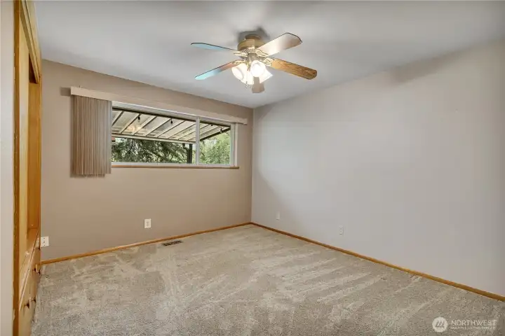 1 of 3 bedrooms with a ceiling fan for added comfort