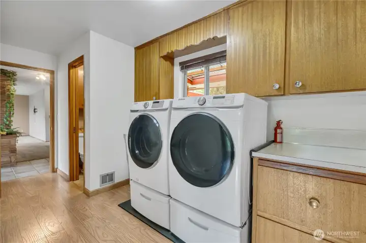 Utility room with W/D that stay with home, cabinetry and counter space