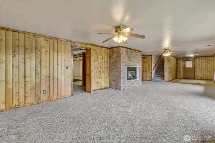 Several additional rooms branch off from this lower living room