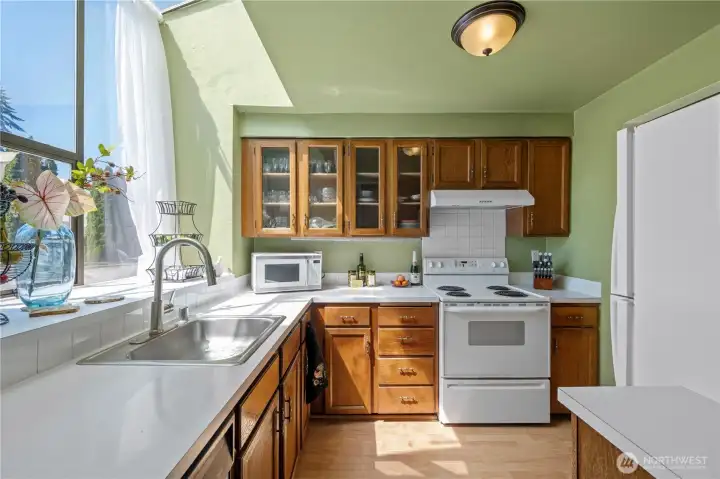 Bright, open-concept interior layout featuring a sunlit kitchen and a seamless transition to the main living space