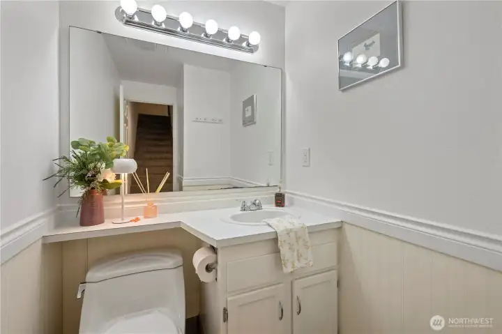 Convenient main-floor powder room featuring a compact vanity and updated fixtures