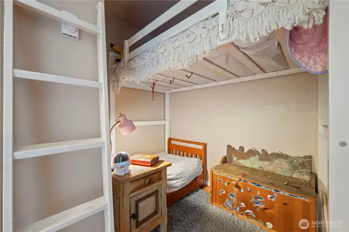 Cozy bedroom layout showcasing a custom-built, space-saving corner bunk bed frame that is fully removable