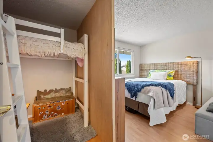 Versatile bedroom space highlighting a built-in corner bunk bed structure, easily dismantled to accommodate a traditional bedroom setup.