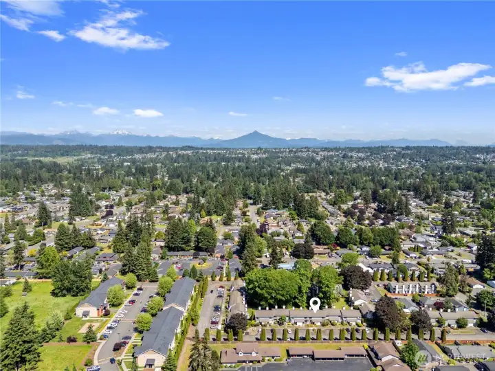 Elevated aerial view showcasing the condominium community set against the backdrop of the Cascade Mountain range