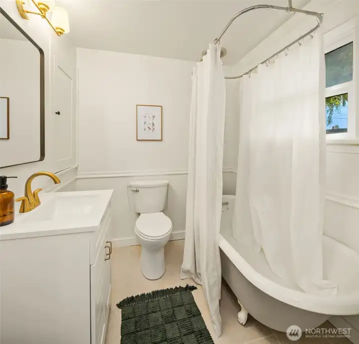 Main Floor Bathroom has been updated but has the vintage clawfoot tub & storage