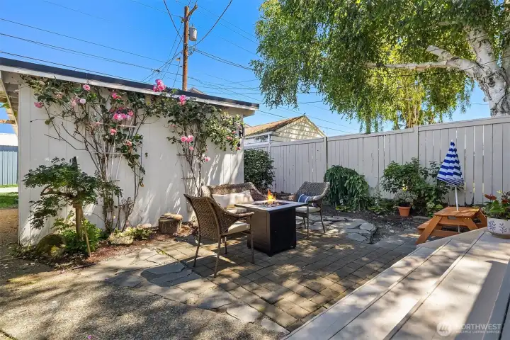 Cute hardscaped back yard is easy to care for while maintaining mature roses and gardening space