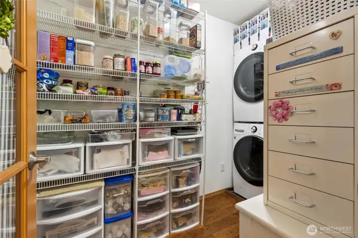 Laundry room and pantry adjacent to kitchen. Stackable washer/dryer stay with the home.