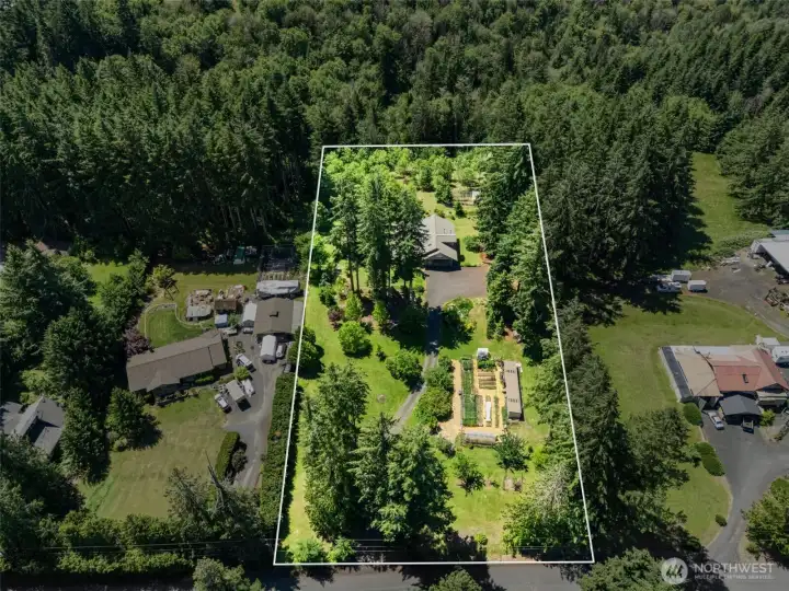 his aerial view captures the full scope of the property, showcasing the home's expansive footprint, private setting, and beautiful natural surroundings. It's a unique perspective that highlights the space, privacy, and lifestyle opportunities this remarkable property has to offer. Approximate property lines shown for reference only.