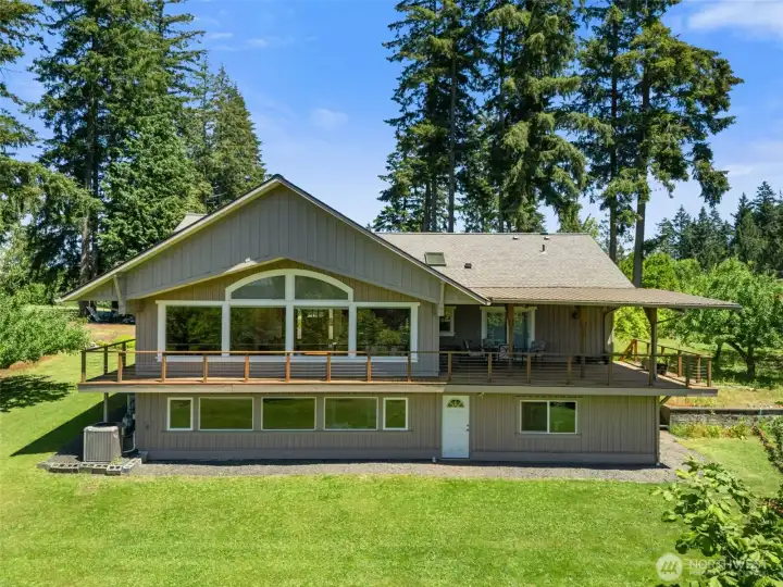 Designed to capture natural light, this home features a daylight basement and large windows that create an open, airy feel throughout. The covered deck provides the perfect place to relax, entertain, or simply take in the tranquil country setting year-round.