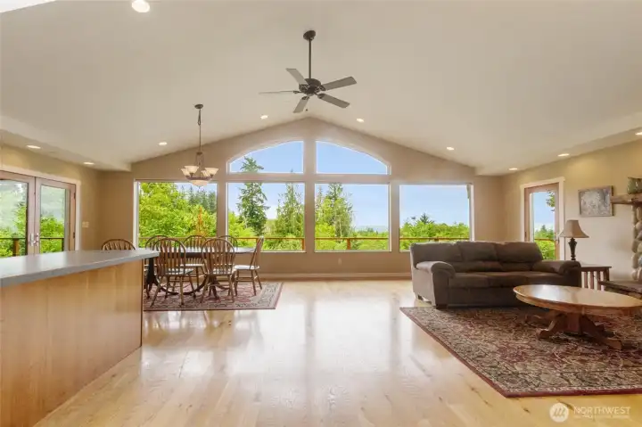 A spectacular wall of windows greets you upon entry, framing sweeping territorial views and filling the home with natural light, creating an inviting connection between the indoors and the surrounding landscape