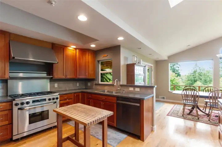 Featuring rich cherry cabinetry and a professional-grade stainless chef’s range, this thoughtfully designed kitchen combines timeless elegance with exceptional functionality, creating a space that will delight seasoned cooks and inspire the next generation of culinary enthusiasts.
