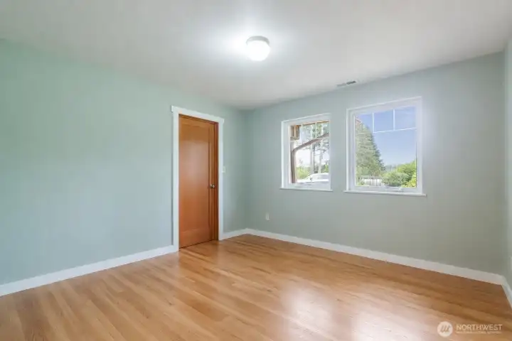 One of three main-floor bedrooms, this inviting space offers comfortable accommodations for guests or everyday living. Its convenient location and versatile layout make it ideal for visitors, or a dedicated workspace.