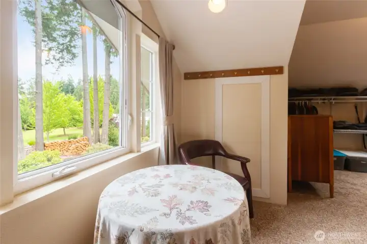 A charming sitting area overlooking natural landscape adds character and warmth to the upper-level flex space. The perfect spot to enjoy your morning coffee, plan the day ahead, dive into a favorite book, or simply relax while taking in the peaceful views of the property.