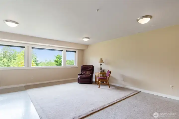 Bright and inviting, this spacious lower-level living area offers endless possibilities for gathering, entertaining, or relaxing. Filled with natural light and featuring convenient exterior access, it's the perfect setting for movie nights, game days, hobbies, or extended living. The flexible layout lends itself well to multi-generational living, guest accommodations.