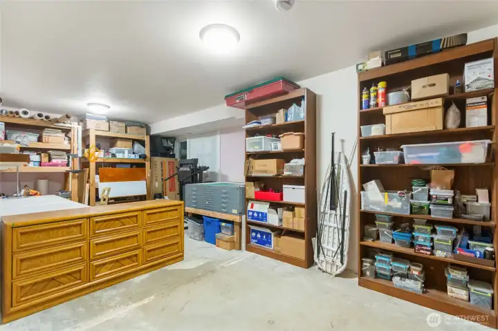 This generously sized unfinished room is currently serving as an art and creative studio, providing plenty of space to work and create. Complete with a closet and private exterior access, it offers endless possibilities for future use, whether as an additional bedroom, home office, workshop, fitness room, or personalized studio.