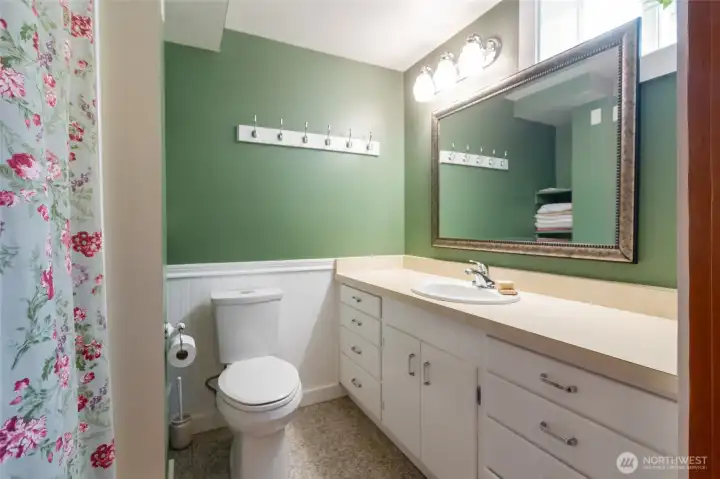 Conveniently situated between the lower-level bedrooms and living areas, this shared guest bath is designed for both comfort and functionality - Ideal for extended stays or multi-generational living.