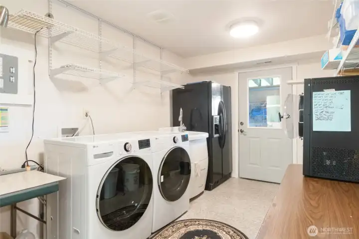 Multi-Purpose Laundry & Storage Area, generously sized and highly functional, this space combines laundry facilities with ample storage for all of life's extras. The exterior entrance is perfect for coming in from the garden or outdoor activities, while easy access to the nearby lower-level bath adds convenience.