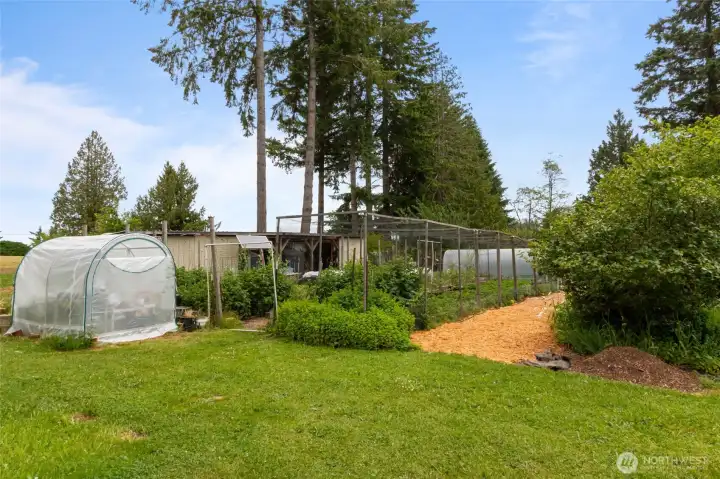 The fenced garden space features new raised garden beds and a water catchment system, creating an ideal setup for growing your own vegetables, herbs, flowers, or berries. Designed with sustainability in mind, the garden offers an opportunity to enjoy farm-to-table living right at home. Prefer a more low-maintenance outdoor space? The seller is willing to remove the garden beds and water catchment system upon request, providing the flexibility to customize the property to fit your lifestyle and vision.