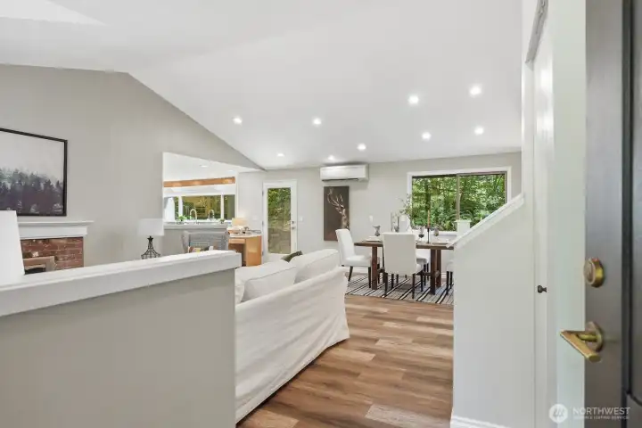 Step inside to a welcoming foyer featuring soaring vaulted ceilings, luxury vinyl plank flooring, and natural light. Step inside to a welcoming foyer featuring soaring vaulted ceilings, luxury vinyl plank flooring, and natural light.