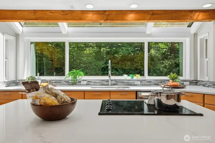 Large center island with additional cabinetry, bar seating, and cooktop creates the perfect gathering space. Large center island with additional cabinetry, bar seating, and cooktop creates the perfect gathering space.
