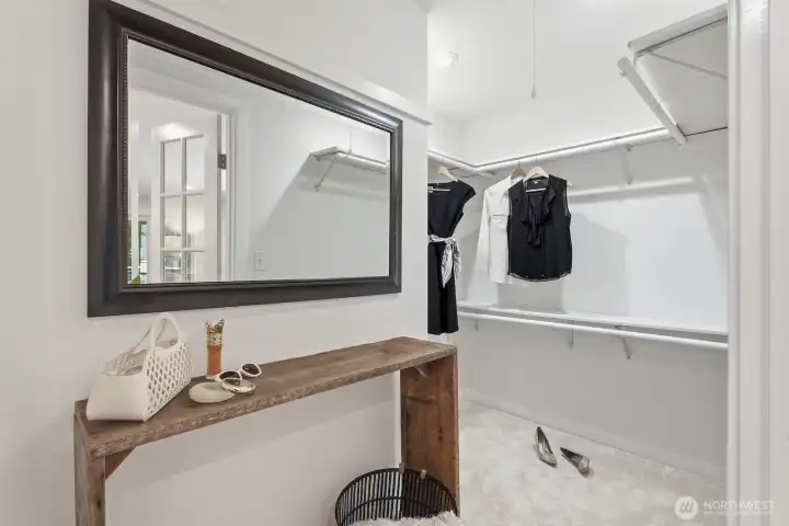 Extended walk-in closet complete with a custom closet organization system and plush carpeting. Extended walk-in closet complete with a custom closet organization system and plush carpeting.