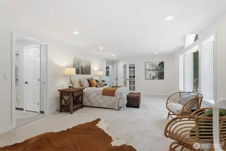 The spacious primary bedroom also features an additional closet, fresh paint, new carpet, and entry into a beautifully remodeled spa-inspired bathroom. The spacious primary bedroom also features an additional closet, fresh paint, new carpet, and entry into a beautifully remodeled spa-inspired bathroom.