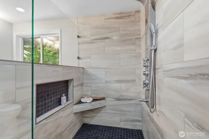 Resort-syle walk-in shower with custom frameless glass enclosure and integrated body jet system for a relaxing, spa-like experience. Resort-syle walk-in shower with custom frameless glass enclosure and integrated body jet system for a relaxing, spa-like experience.