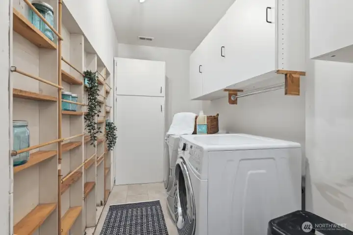 Generously sized laundry room includes updated flooring, built-in cabinetry, and dedicated canning or storage space. Generously sized laundry room includes updated flooring, built-in cabinetry, and dedicated canning or storage space.