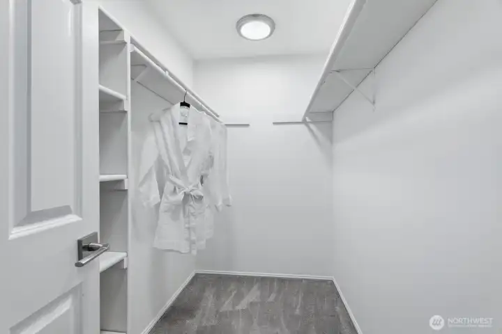 Spacious walk-in closet with a custom closet organization system. Spacious walk-in closet with a custom closet organization system.