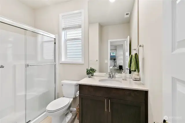 This walk-in-shower offers accessibility and it's located close to the main floor guest suite.