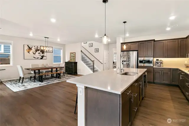 Paired with gourmet stainless steel appliances, including top-of-the-line ovens, cooktops, and refrigerators, this kitchen is a chef's dream come true.