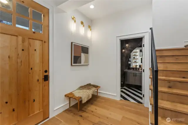 Entryway onlooking to the powder bath. Extensive attention to detail throughout the home.