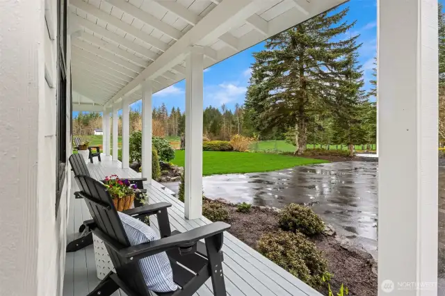 Quintessential covered wrap around deck to relax on this Pacific Northwest Retreat.
