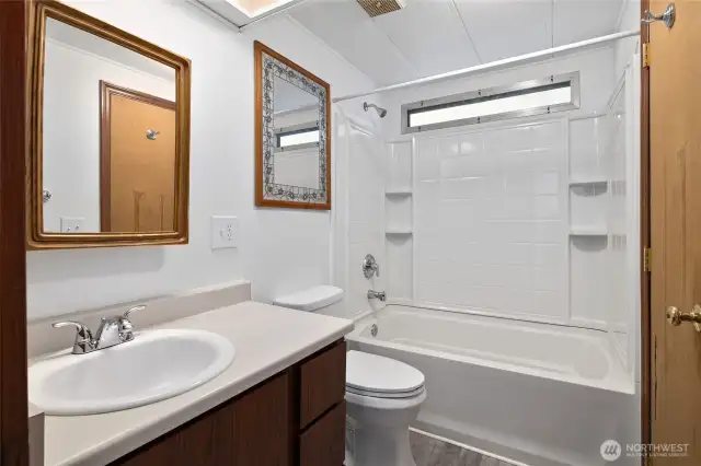 Full guest bathroom with new surround and new laminate flooring.