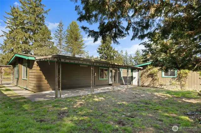 Back of the home out the french doors has a large covered patio area and fully fenced yard.