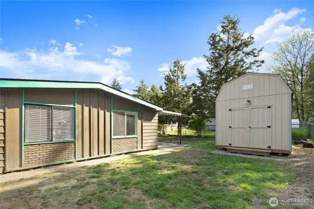 Side of home and the LARGE 10' X 28' Storage Shed.