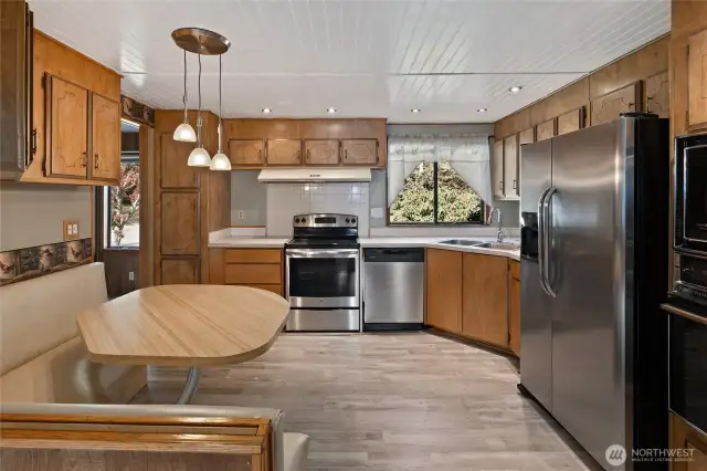 Your Kitchen features new stainless steel appliances and the perfect breakfast nook with table and benches.