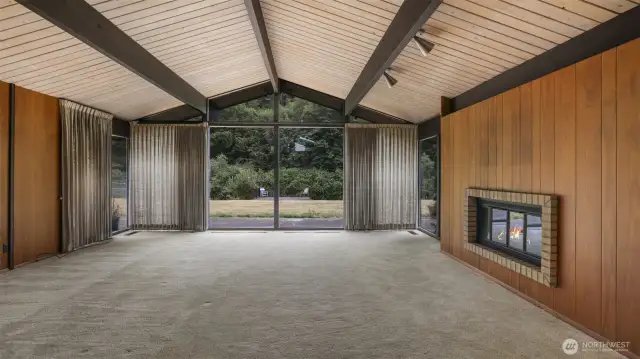 From the entry you'll flow into the living room with vaulted ceilings, exposed beams and a stately dual-sided wood burning fireplace.